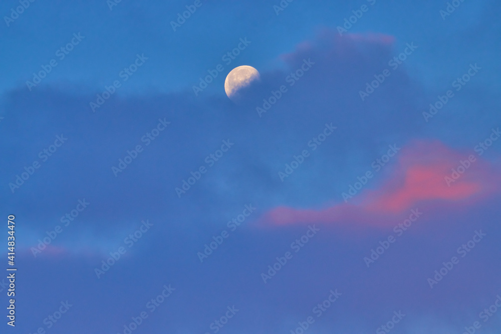 Moon at sunrise behind the cloud Moon at sunrise behind the cloud