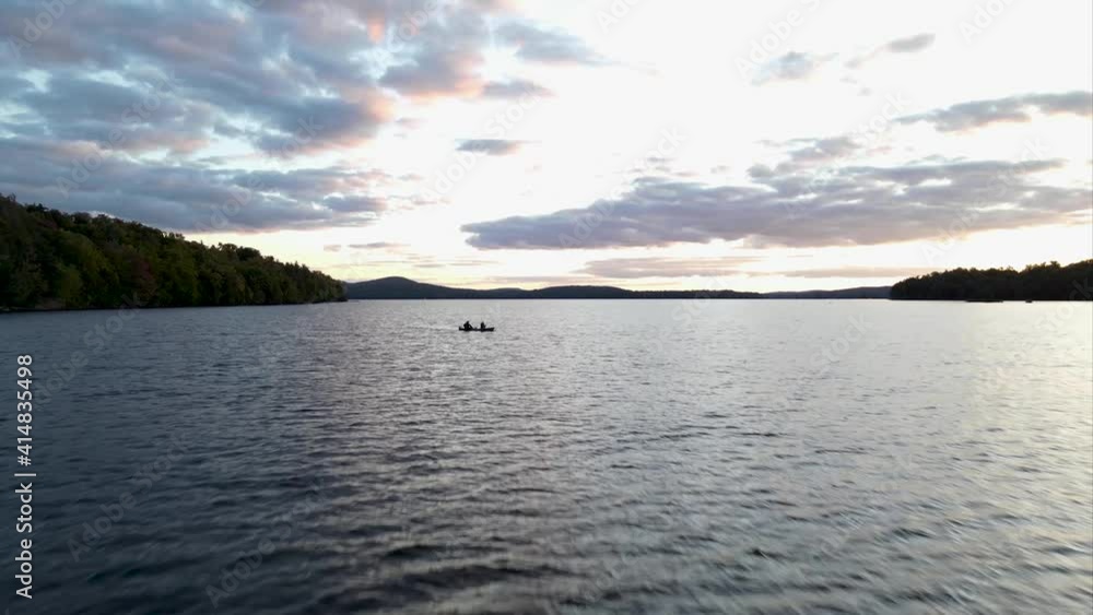 Cinematic drone flying over water in the Adirondacks flying over canoe Cinematic drone flying over water in the Adirondacks flying over canoe