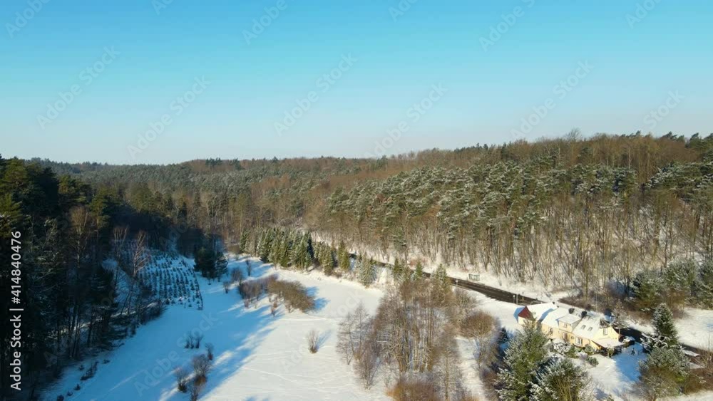 Shadows of a streched out forest with giant trees over a field which is covered with white snow on a bright sunny winter day near Gdansk in Poland. Reversed drone dolly shot Shadows of a streched out forest with giant trees over a field which is covered with white snow on a bright sunny winter day near Gdansk in Poland. Reversed drone dolly shot