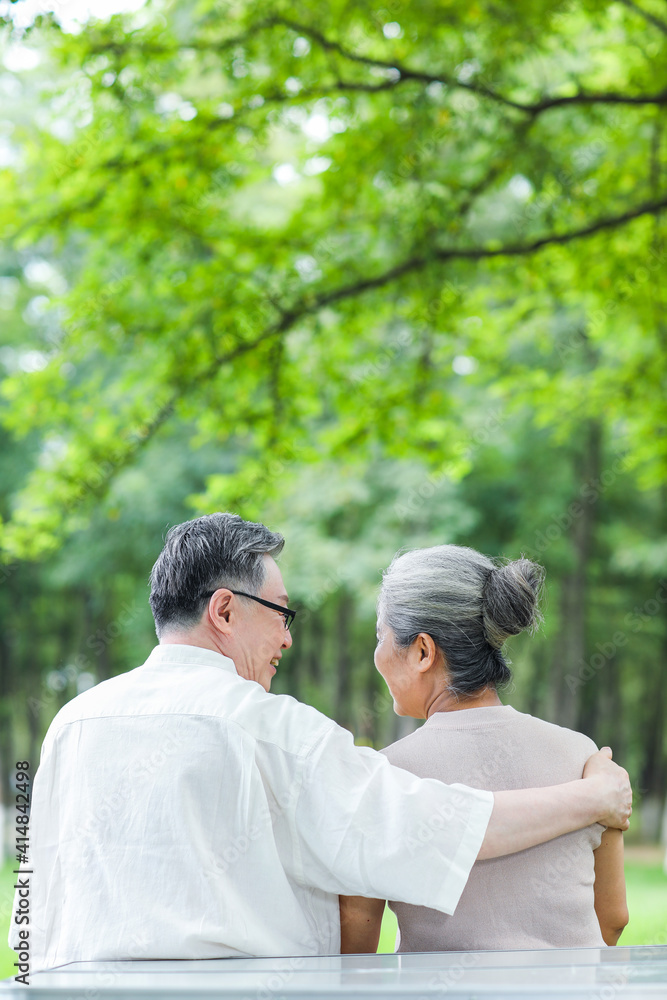 Happy old couple sitting on chairs in outdoor park Happy old couple sitting on chairs in outdoor park