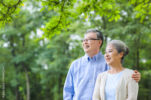 Happy old couple looking at the scenery in the park