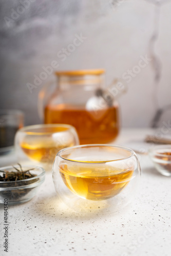 light tea flatley. pour black tea into thermos cups, on a light background. tea ceremony with different types of leaf tea