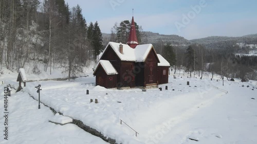 Static areal footage of Rollag stave church in Norway . Winter photo