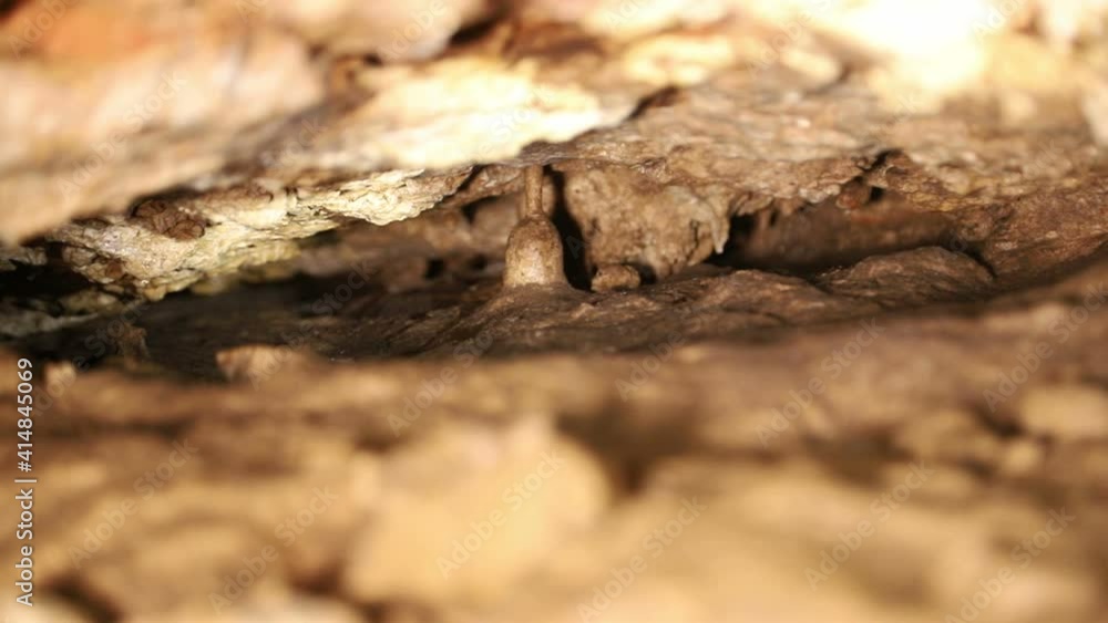 Natural cave in the rock. A cave that is underground with beautiful illuminated stones, stalagmites. Natural cave in the rock. A cave that is underground with beautiful illuminated stones, stalagmites.
