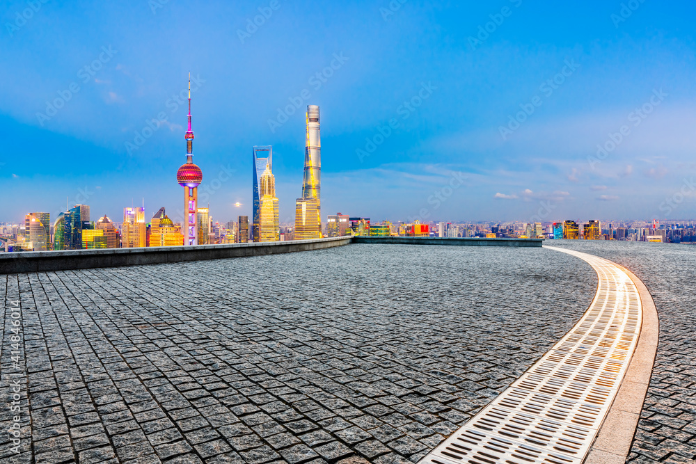 Fototapeta premium Empty square floor and Shanghai skyline with buildings at night,China.High angle view.