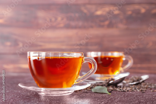 Cups of hot tea on wooden background