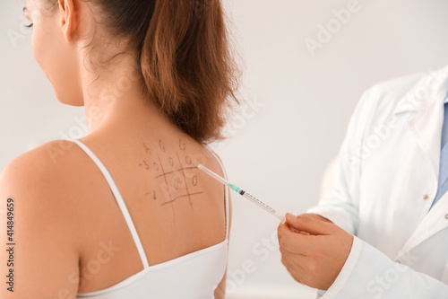 Young woman undergoing allergen skin test in clinic photo