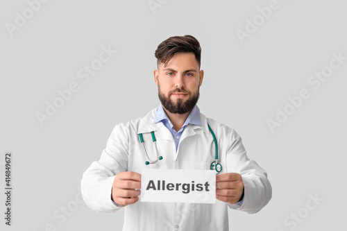 Doctor holding paper with w...