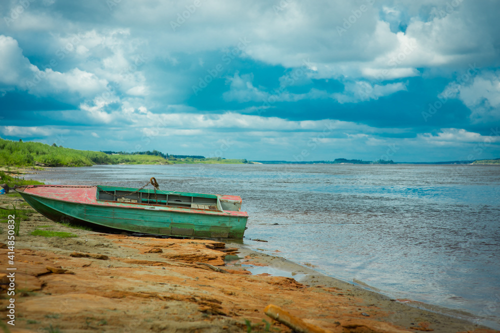 landscape with boat, river and stormy sky, selective focus