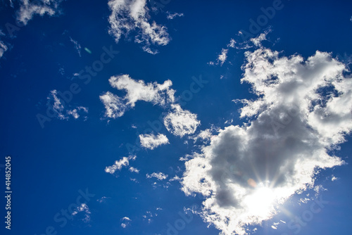 Fototapeta Naklejka Na Ścianę i Meble -  太陽光線と流れてゆく白い雲