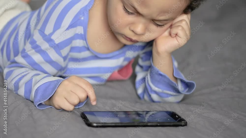 boy looking at his tablet mobile phone on tablet in the bedroom stock footage stock video boy looking at his tablet mobile phone on tablet in the bedroom stock footage stock video