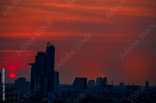 The high angle background of the city view with the secret light of the evening, blurring of night lights, showing the distribution of condominiums, dense homes in the capital community