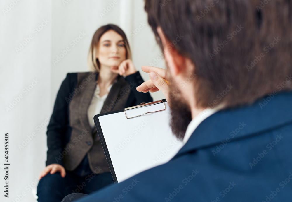A man communicates with a woman and documents are in the hands of a psychologist at a doctor's appointment A man communicates with a woman and documents are in the hands of a psychologist at a doctor's appointment