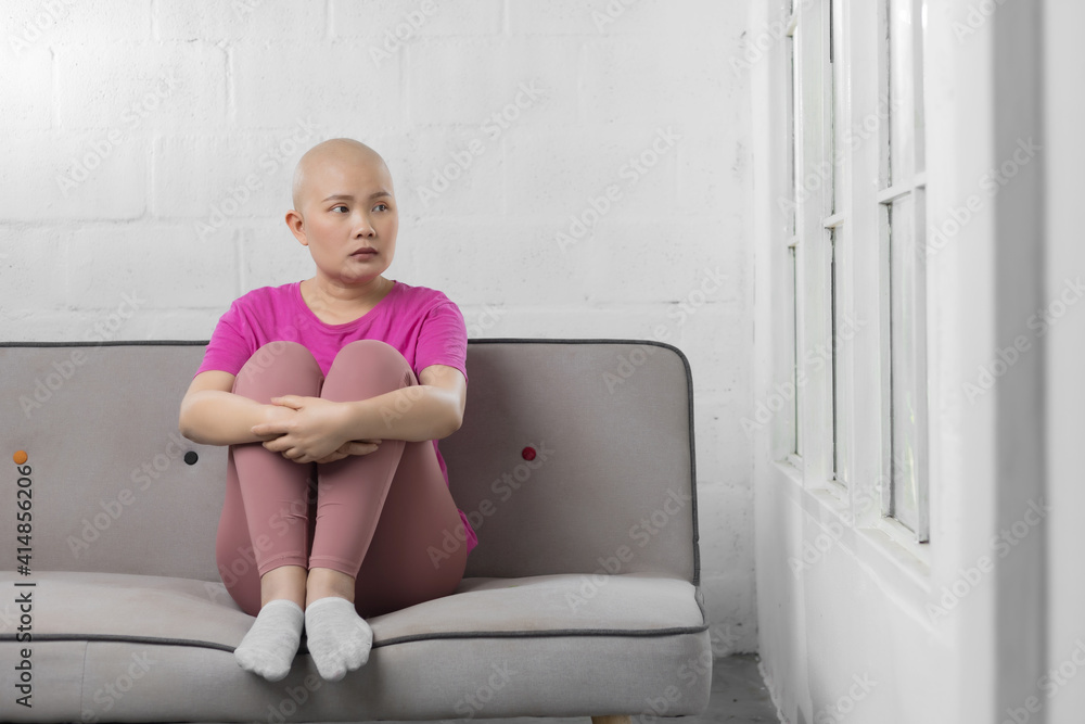Portrait of sad Asian woman cancer patient after suffering serious hair loss due to chemotherapy Portrait of sad Asian woman cancer patient after suffering serious hair loss due to chemotherapy