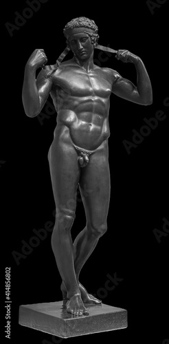 Ancient white marble full length sculpture of naked young man. Antique classic statue of youngster isolated on black. Stone figure of teenager