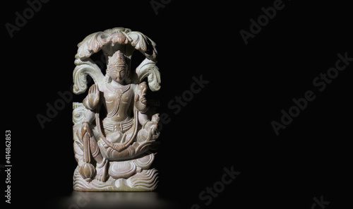 Photos Buddhist figurine made of soapstone on a black isolated background