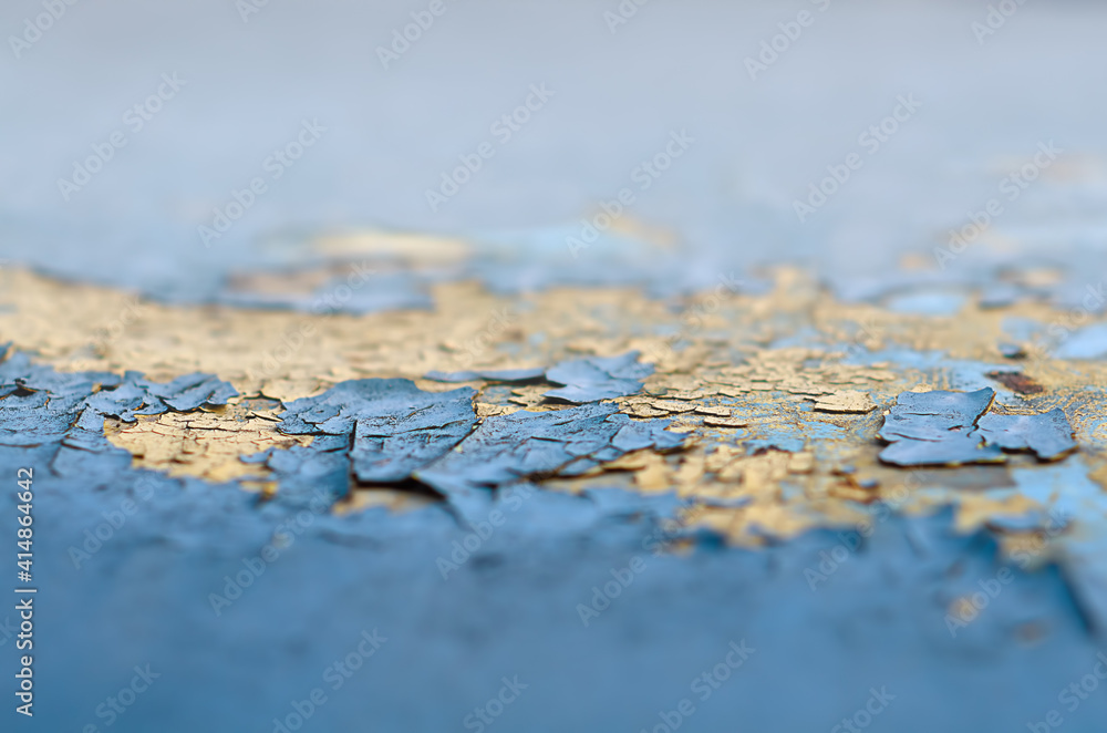 shabby blue and yellow paint in selective focus on a metal surface shabby blue and yellow paint in selective focus on a metal surface
