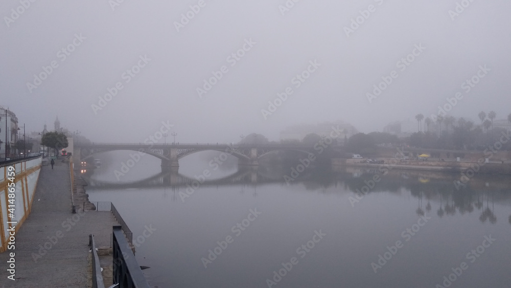 Bridge over the river Guadalquivir in a misty morning, Triana, Seville, Spain
