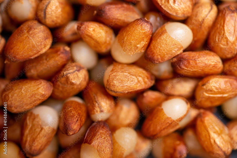Background of peeled pine nuts from Siberia, milky color with a yellow dry skin. Background of peeled pine nuts from Siberia, milky color with a yellow dry skin.