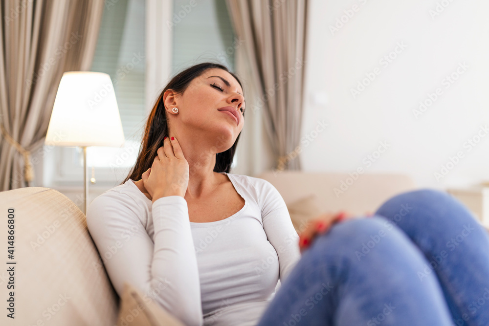 Young woman feeling pain in neck . Tired female suffering of office syndrome because of long hours computer work. Pretty girl massaging her tense neck muscles Young woman feeling pain in neck . Tired female suffering of office syndrome because of long hours computer work. Pretty girl massaging her tense neck muscles