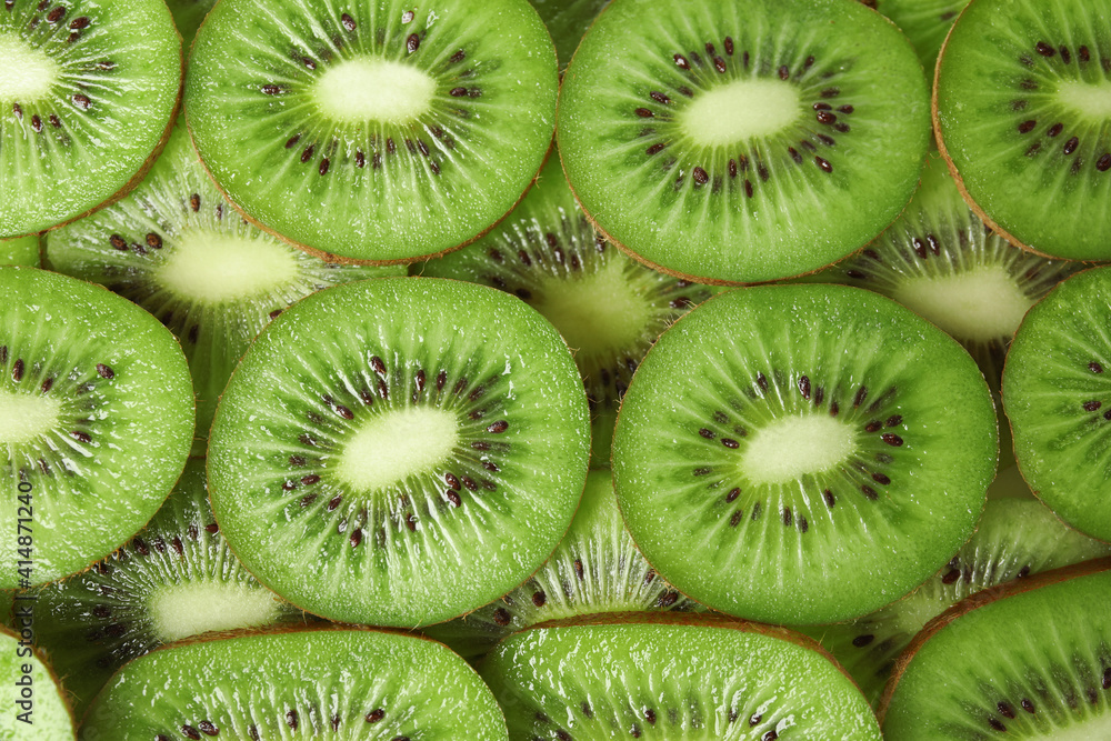 Sliced fresh ripe kiwis as background, top view Sliced fresh ripe kiwis as background, top view