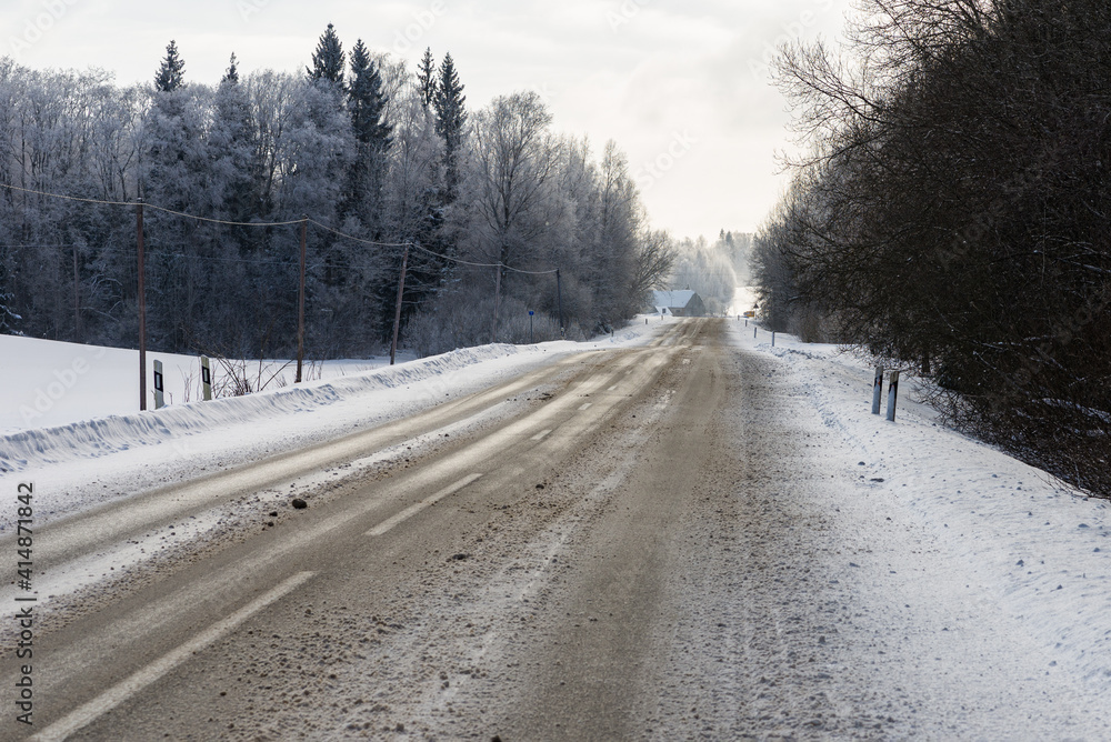 Winter road in snowy forest on a cold day. Winter road in snowy forest on a cold day.