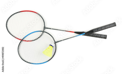 Rackets and shuttlecock on white background, top view. Badminton equipment