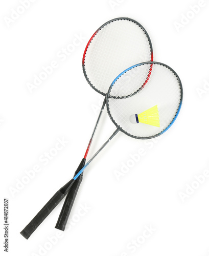 Rackets and shuttlecock on white background, top view. Badminton equipment