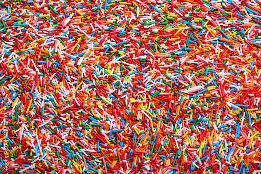 Bright colorful sprinkles as background, top view. Confectionery decor Bright colorful sprinkles as background, top view. Confectionery decor