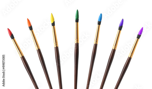 Collage of brushes with different bright paints on white background
