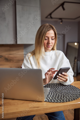 Focused lady clicking on her mobile phone
