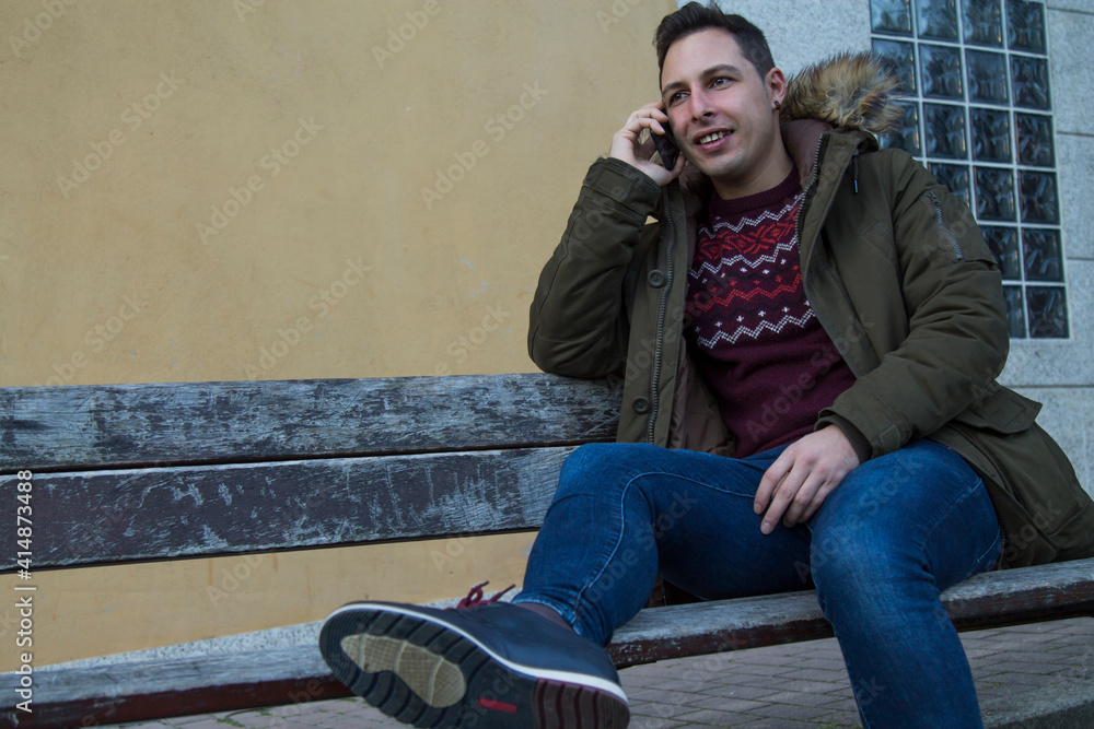 man sitting on the bench talk on the mobile phone man sitting on the bench talk on the mobile phone