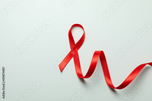 Red awareness ribbon on white background, space for text