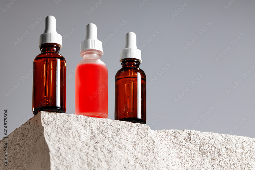 Glass bottle with cosmetic oil on cinder block Glass bottle with cosmetic oil on cinder block