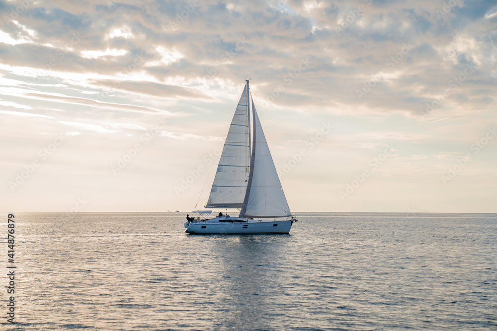 Sailboat in the sea in the sunset, luxury summer adventure, in Mediterranean sea, Europe