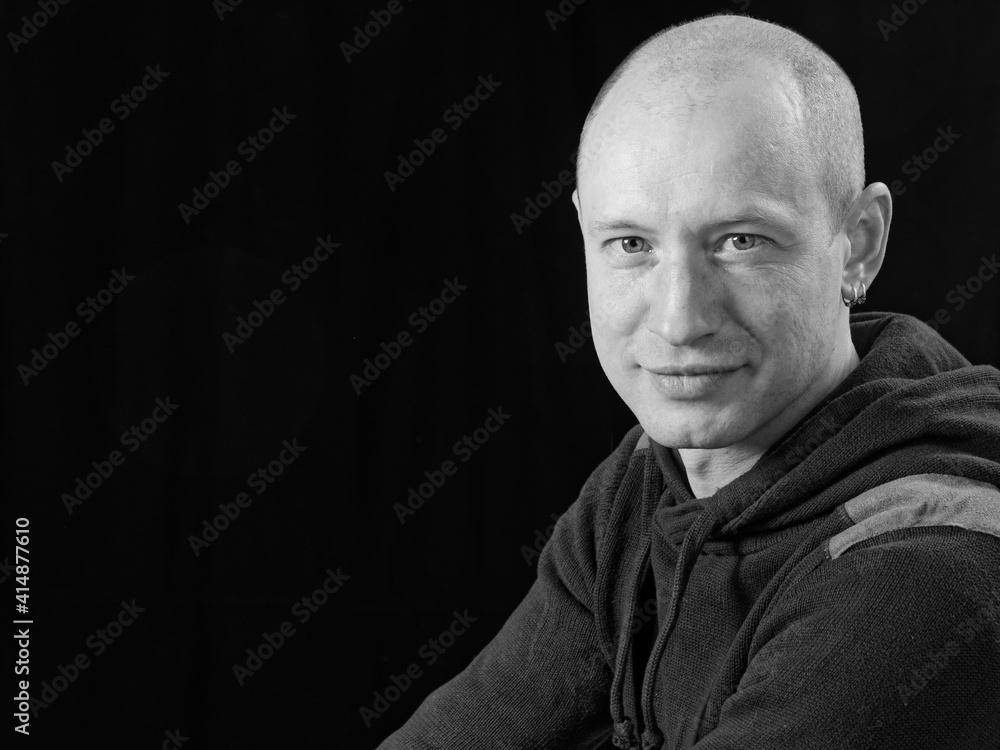 bw portrait of a bald man on a black background