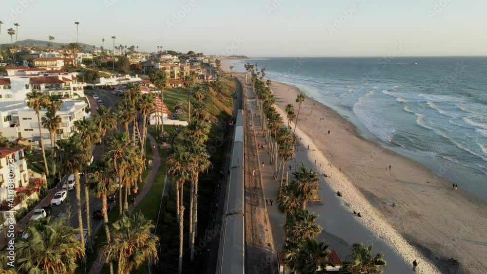 Flying over railroad at sunset, San Clemente Pier Beach, California, aerial wide slow motion shot Flying over railroad at sunset, San Clemente Pier Beach, California, aerial wide slow motion shot