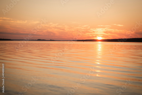 sunset in warm colors over the river, selective focus © Ekaterina