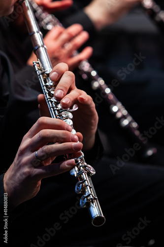 Fotografie Hands of a musician playing the flute close up