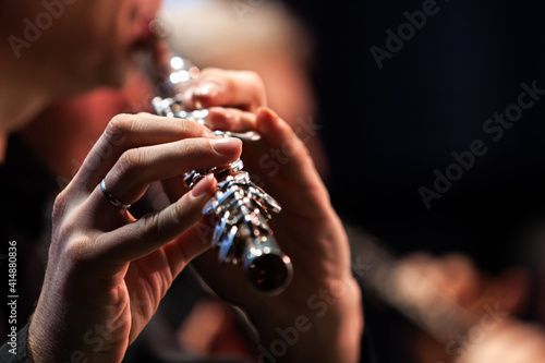 Canvas Print Hands of a musician playing the flute close up