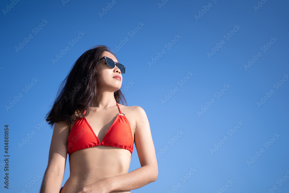 Portrait of a beautiful woman wearing a red bikini with a clear sky on vacation. Portrait of a beautiful woman wearing a red bikini with a clear sky on vacation.