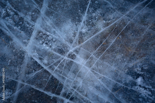 cracked ice texture, abstract seasonal winter cold background, natural ice, broken ice on a lake © kichigin19