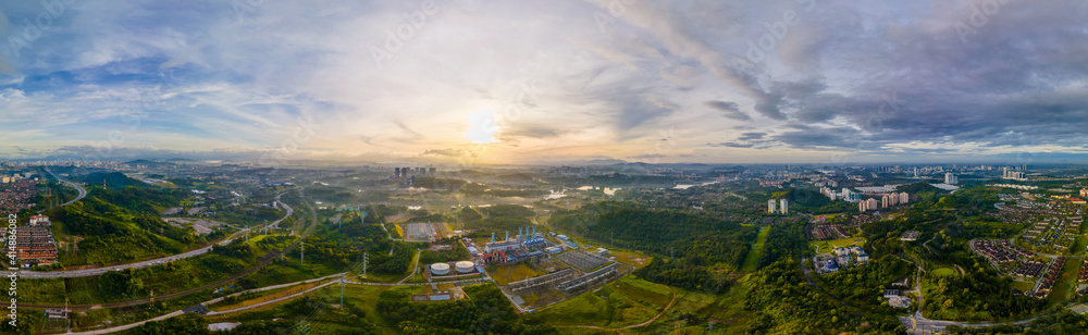 Fototapeta premium Aerial Panorama view of a Gas Turbine Power Plant Station during sunrise. Gas Turbine converts Natural Gas or other liquid fueils to Mechanical Energy