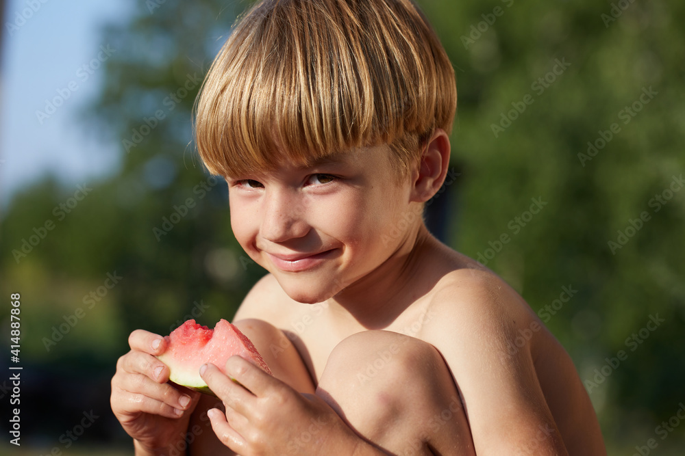 Smiling young boy eating watermelon in outdoor Smiling young boy eating watermelon in outdoor