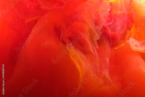 Red yellow abstract background of flowing fluid.