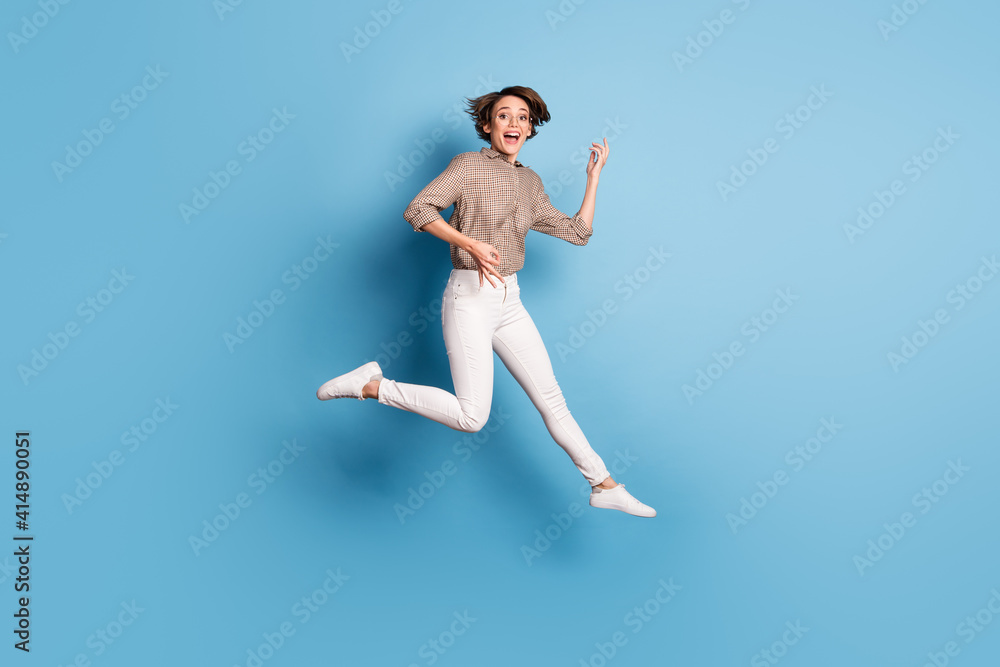 Obraz premium Full size portrait of cheerful person jump high hands playing imagine guitar isolated on blue color background