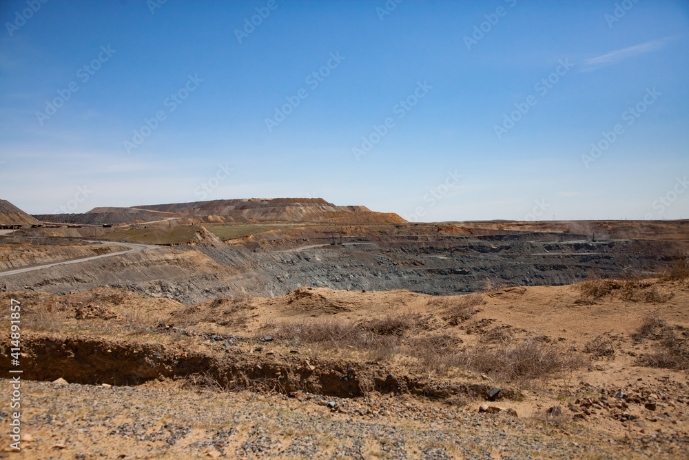 Copper ore open-pit mining. (Quarry). Panorama view, blue sky.