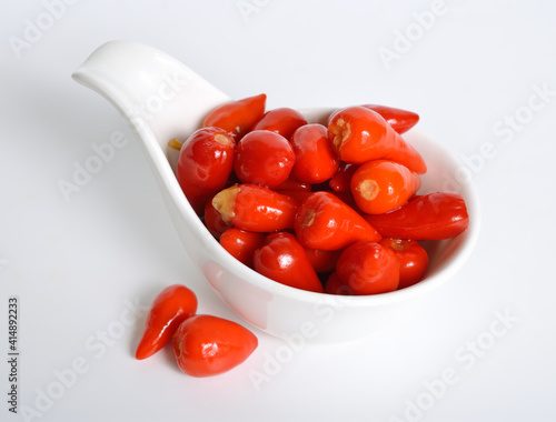 Small hot red chili pickled on white background photo