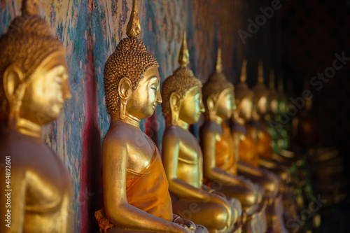 Buddha statue in Wat Arun at Bangkok  Thailand. Row of famous ancient buddha statue at Wat Arun.