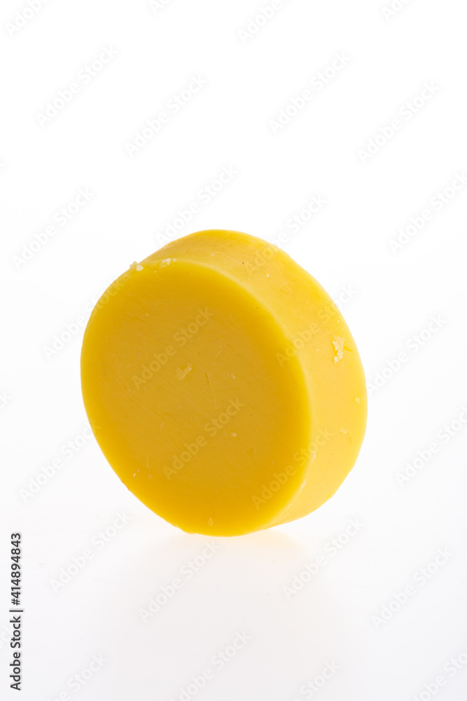 Yellow round piece of soap on a white background. Yellow round piece of soap on a white background.